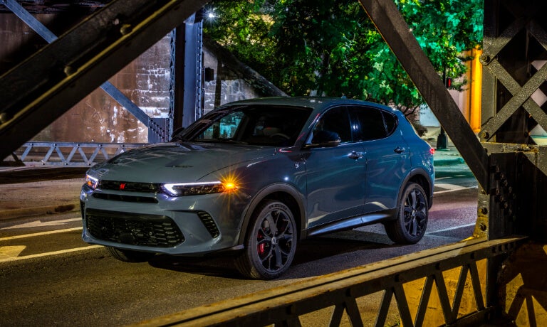 2024 Dodge Hornet driving under a city bridge
